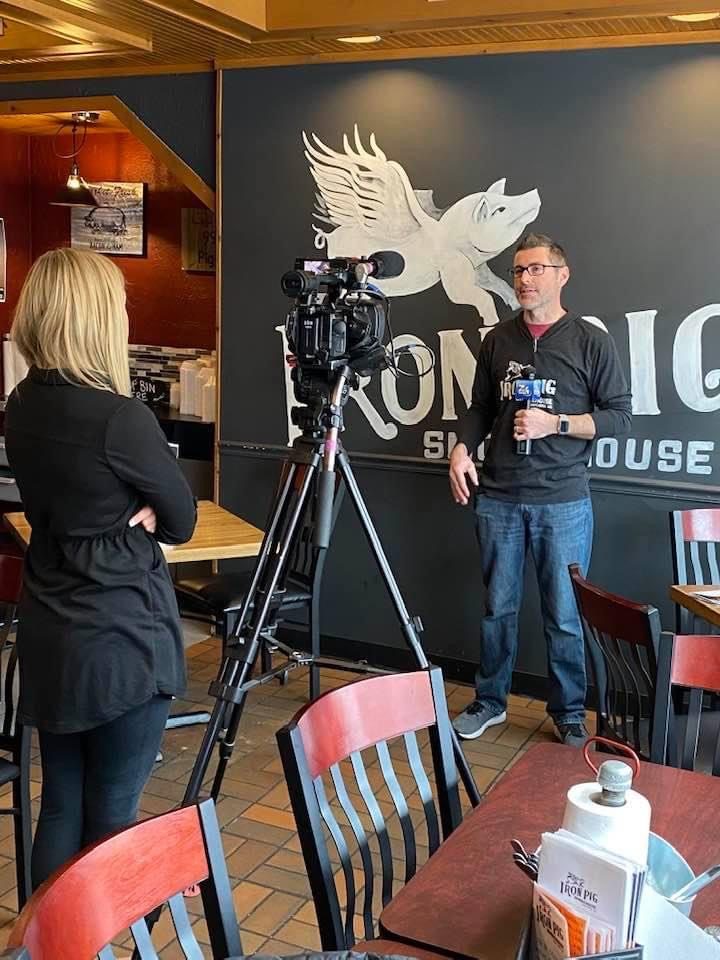 Ian interviewed under the Iron Pig mural